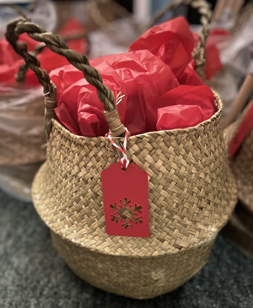 woven basket with red paper on top and red tag.